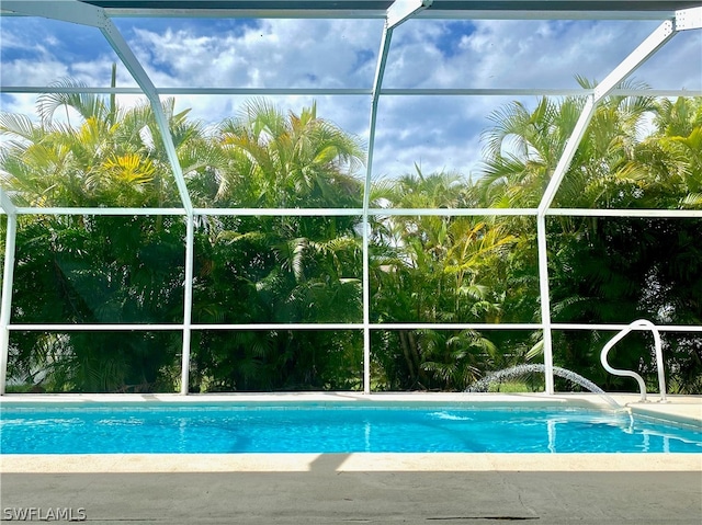 view of swimming pool with a lanai