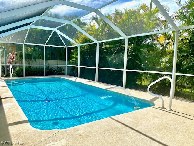 view of pool with a patio area and a lanai