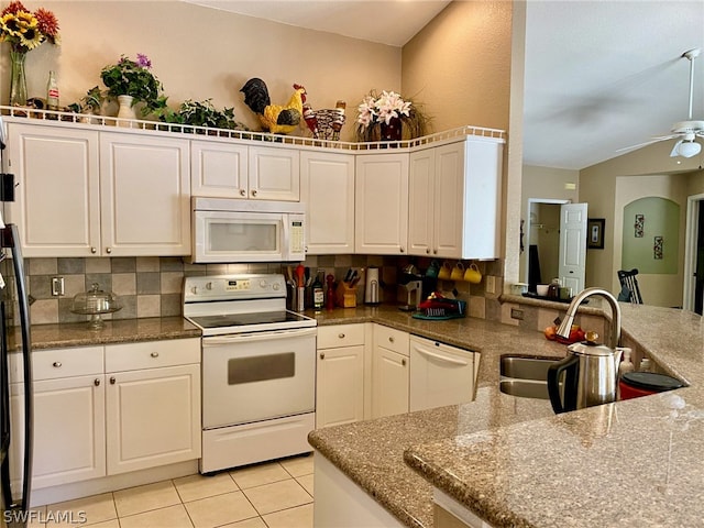 kitchen with white appliances, white cabinets, light tile patterned floors, decorative backsplash, and ceiling fan