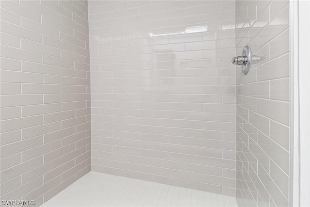 bathroom with tiled shower