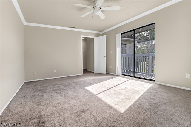 empty room with crown molding, carpet, and ceiling fan