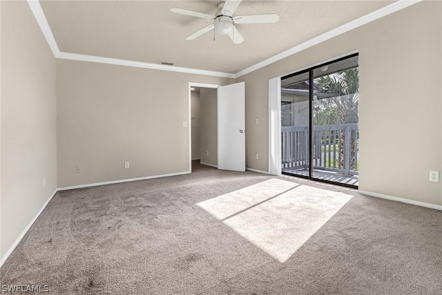 carpeted empty room with baseboards, ceiling fan, ornamental molding, and visible vents