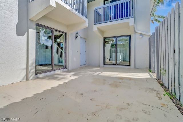 property entrance featuring a patio area and a balcony