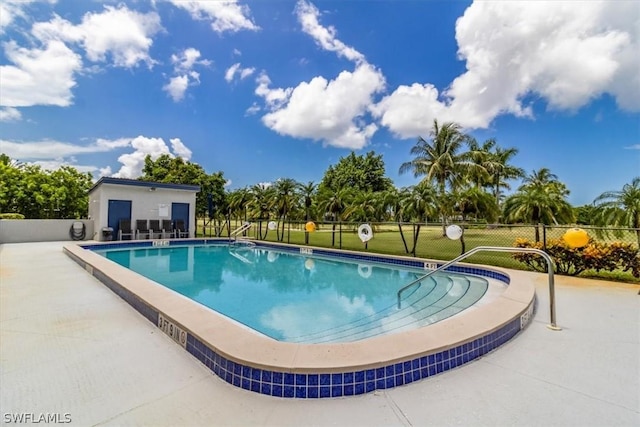 pool featuring a patio area and fence