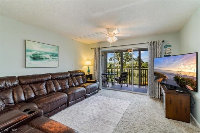 living room with light carpet, a textured ceiling, and ceiling fan