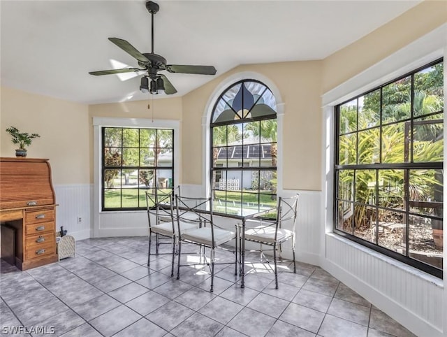 dining room with ceiling fan, light tile patterned flooring, plenty of natural light, and lofted ceiling