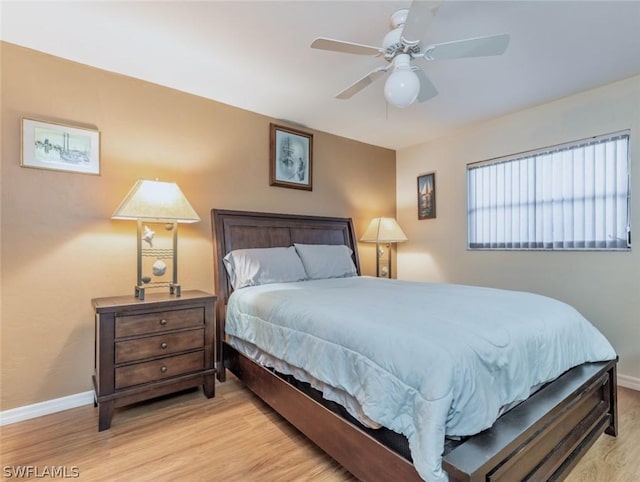 bedroom with ceiling fan and light hardwood / wood-style flooring