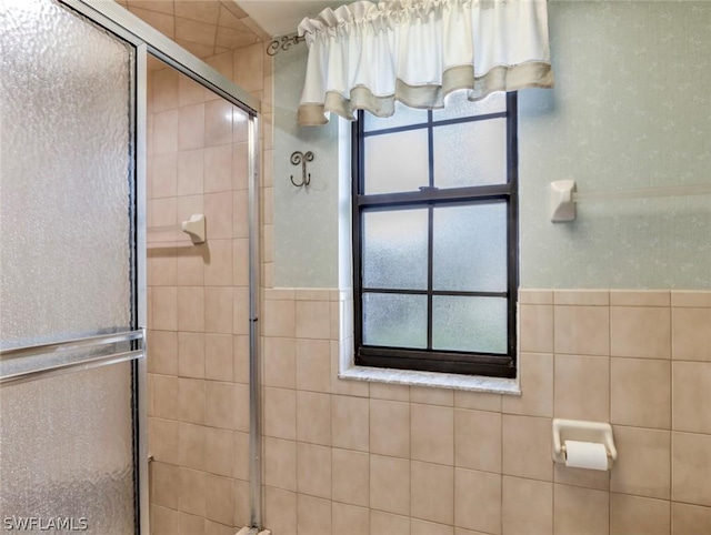 bathroom featuring a shower with door