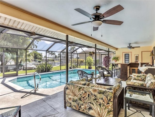 view of swimming pool featuring outdoor lounge area, glass enclosure, a bar, and a patio