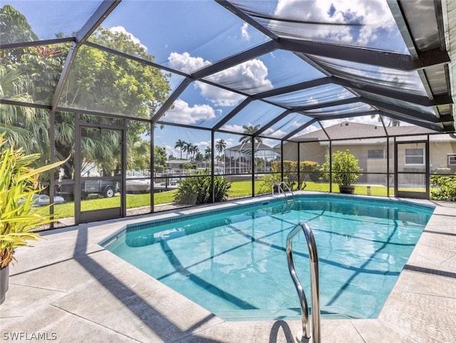 view of swimming pool featuring a patio and glass enclosure