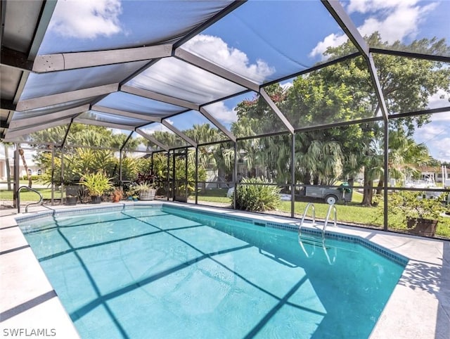 view of swimming pool featuring glass enclosure