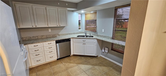 kitchen featuring light stone counters, dishwasher, white cabinetry, sink, and light tile floors