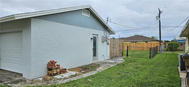 view of side of property with a garage and a yard