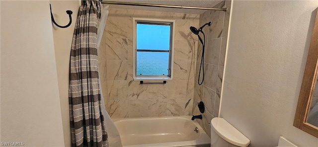 bathroom with shower / bath combination with curtain and toilet