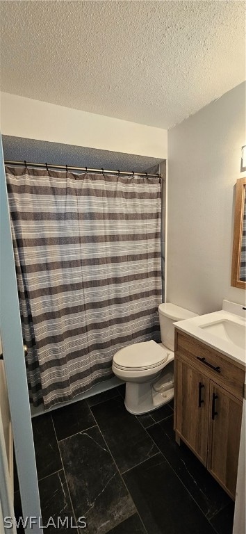 bathroom with tile flooring, vanity, toilet, and a textured ceiling