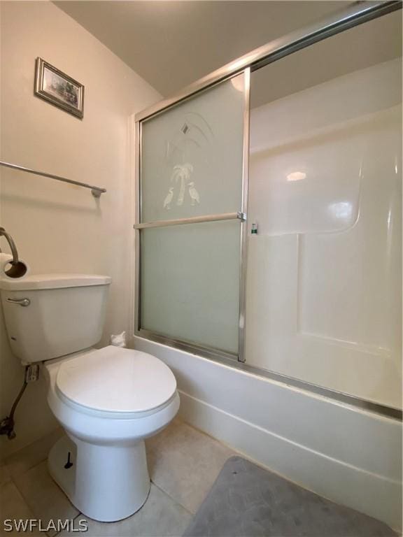 bathroom with toilet, enclosed tub / shower combo, and tile patterned floors