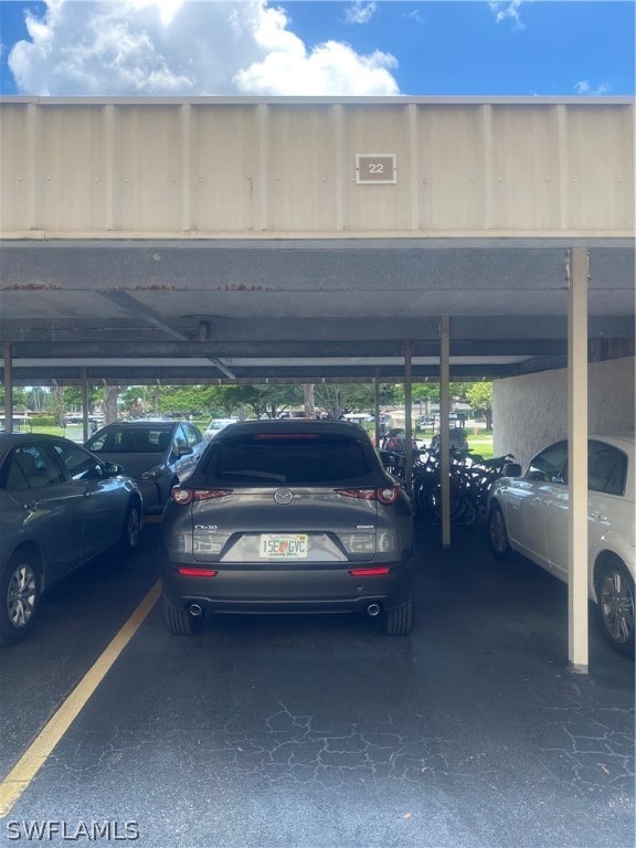 view of parking / parking lot featuring a carport