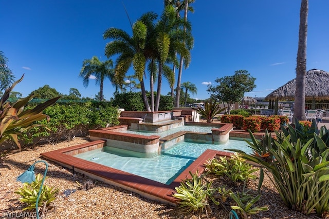 view of pool with an in ground hot tub