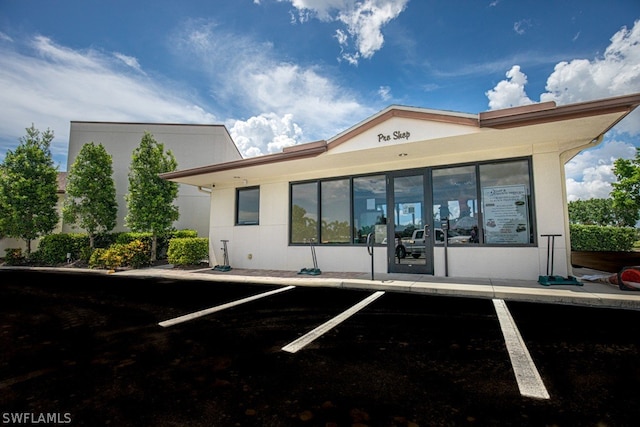 view of building exterior featuring uncovered parking