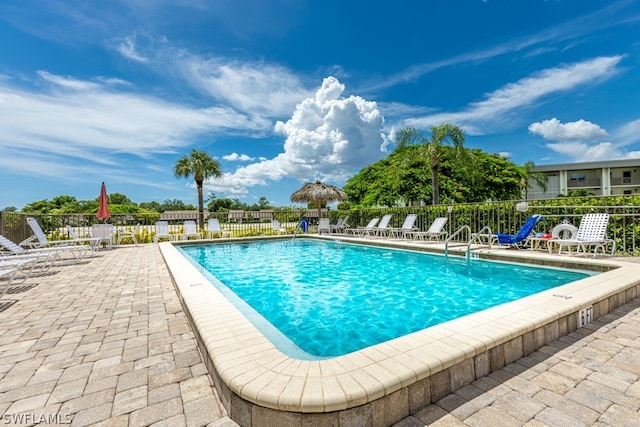 pool featuring a patio area and fence