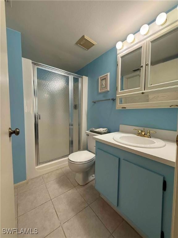 bathroom with a shower stall, tile patterned floors, visible vents, and vanity