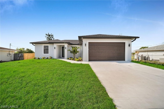 view of front facade featuring a garage and a front lawn