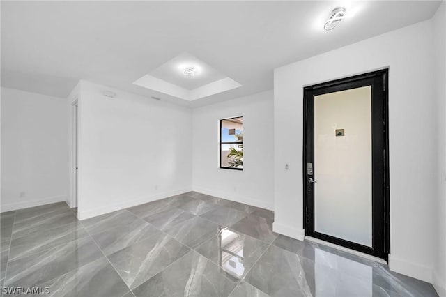 spare room featuring a tray ceiling