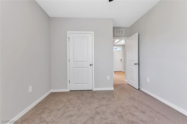 unfurnished bedroom featuring light carpet