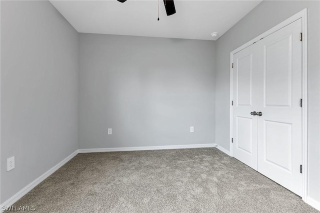 unfurnished bedroom featuring ceiling fan and light colored carpet