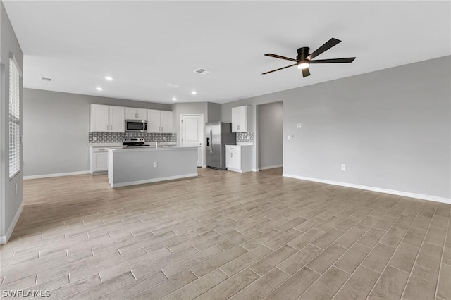 unfurnished living room with light hardwood / wood-style flooring and ceiling fan