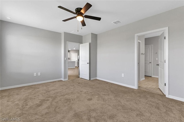 unfurnished bedroom with ceiling fan and light carpet