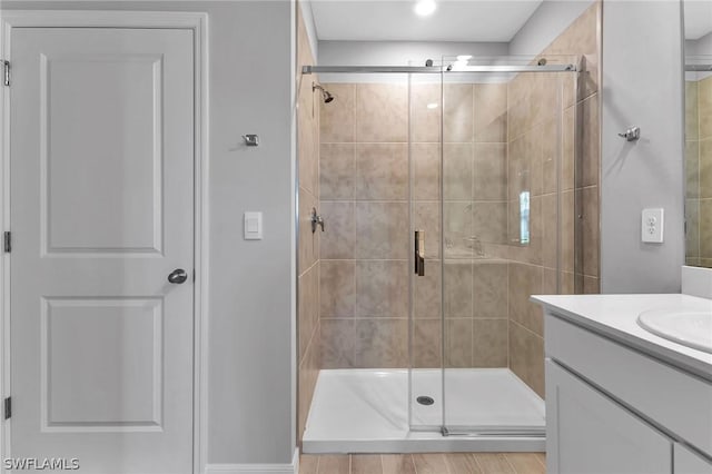 bathroom featuring vanity and a shower with shower door