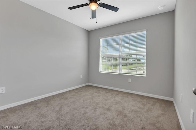 carpeted spare room with ceiling fan