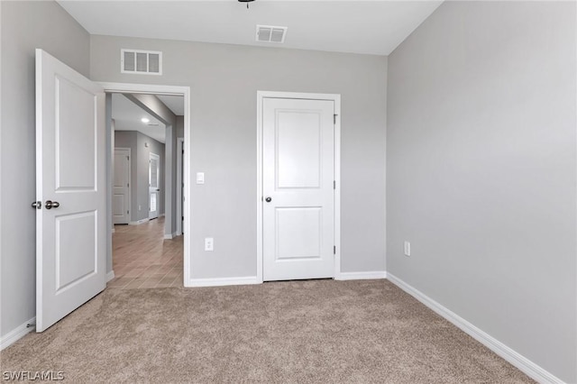 unfurnished bedroom with light colored carpet