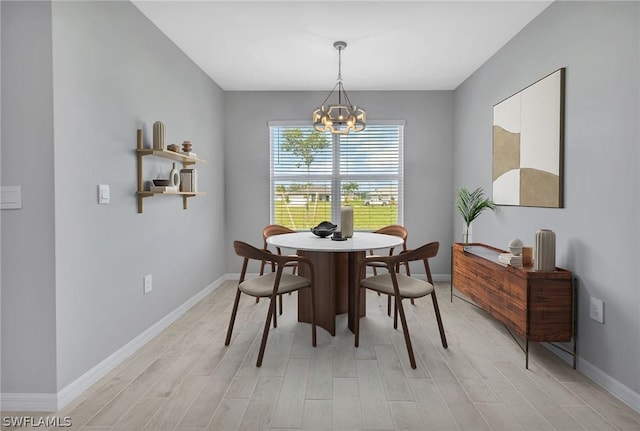 dining room featuring light wood-type flooring and a notable chandelier