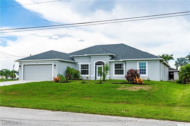 view of front of property featuring a front yard and a garage