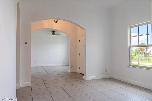 unfurnished room featuring ceiling fan and light tile patterned flooring