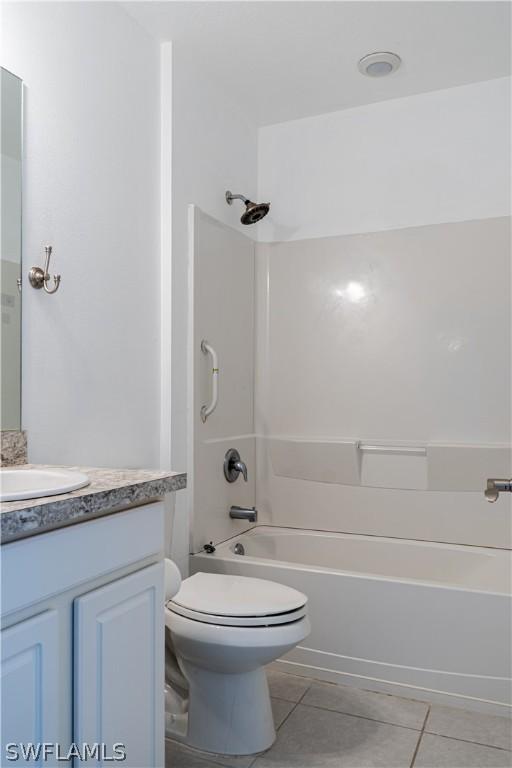 full bathroom featuring toilet, vanity, bathing tub / shower combination, and tile patterned floors