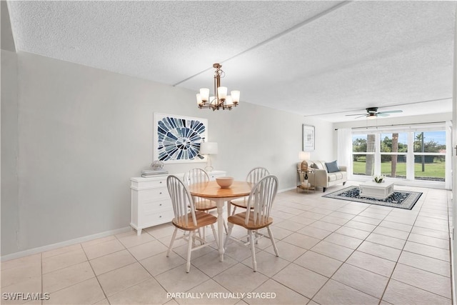 dining space featuring light tile patterned floors, ceiling fan with notable chandelier, and a textured ceiling