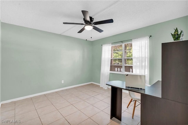 unfurnished office featuring ceiling fan, light tile patterned floors, and a textured ceiling