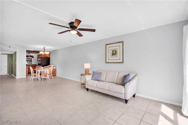 living room with ceiling fan with notable chandelier and light tile patterned flooring