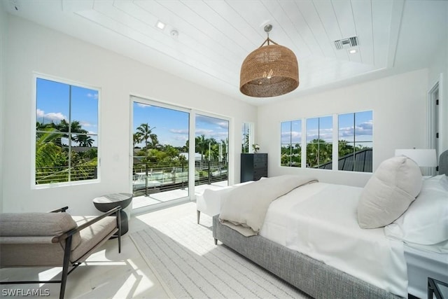 bedroom with wooden ceiling, access to outside, and multiple windows