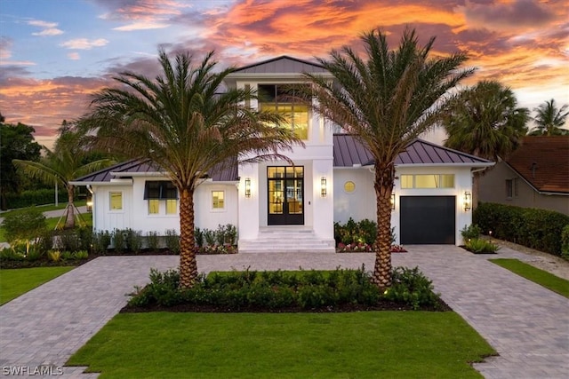 view of front of house with a lawn and french doors