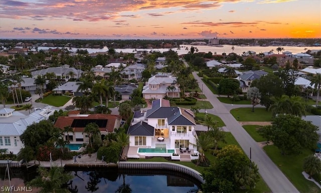 aerial view at dusk with a water view