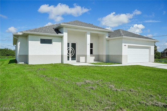 view of front of home with a garage and a front yard