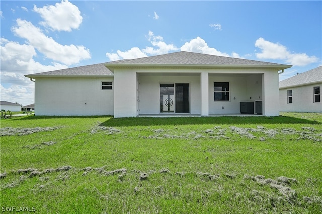 rear view of house with a yard