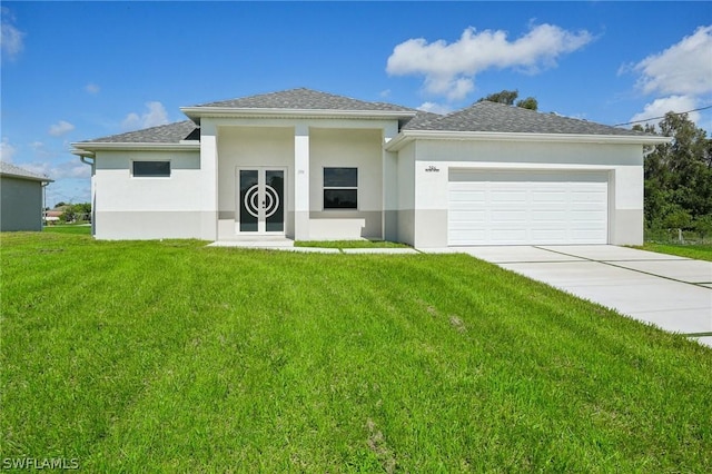 view of front of property with a garage and a front lawn