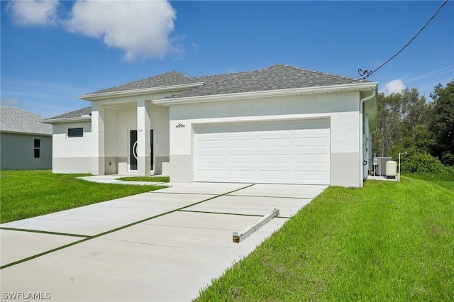 view of front of home featuring central AC unit, a garage, and a front yard