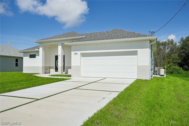 view of front facade with a garage, a front yard, and cooling unit