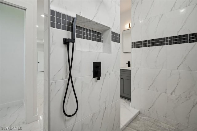 bathroom featuring walk in shower and vanity